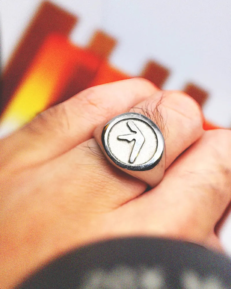 Person wearing Aphex Twin logo stainless steel ring – durable fan accessory in size 5-12