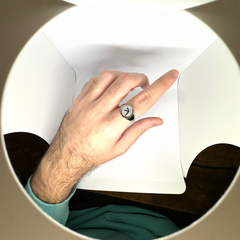 Person wearing Aphex Twin logo stainless steel ring – durable fan accessory in size 5-12
