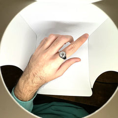 Person wearing Aphex Twin logo stainless steel ring – durable fan accessory in size 5-12