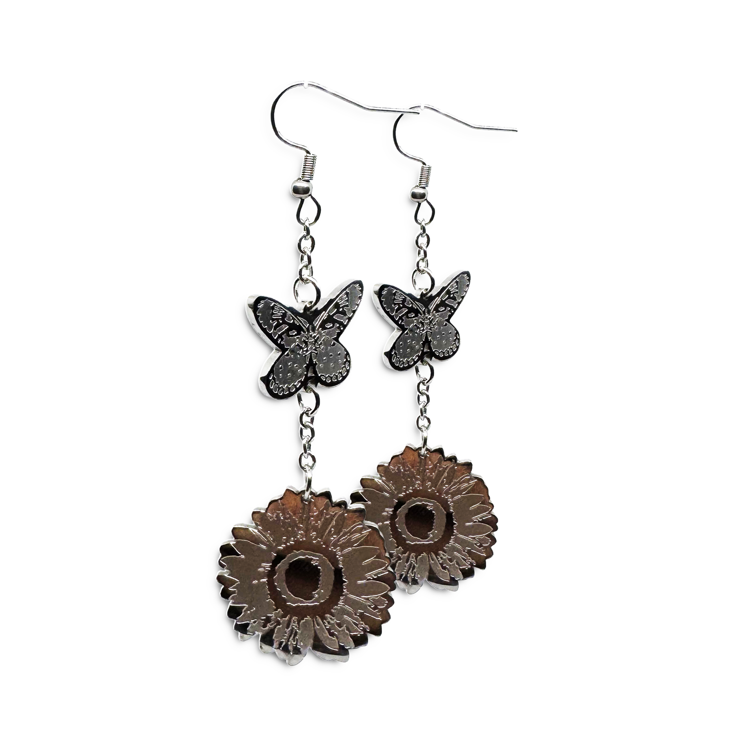 Close-up of Indie Ovation Butterfly & Sunflower earrings in stainless steel, 1-inch engraved nature design