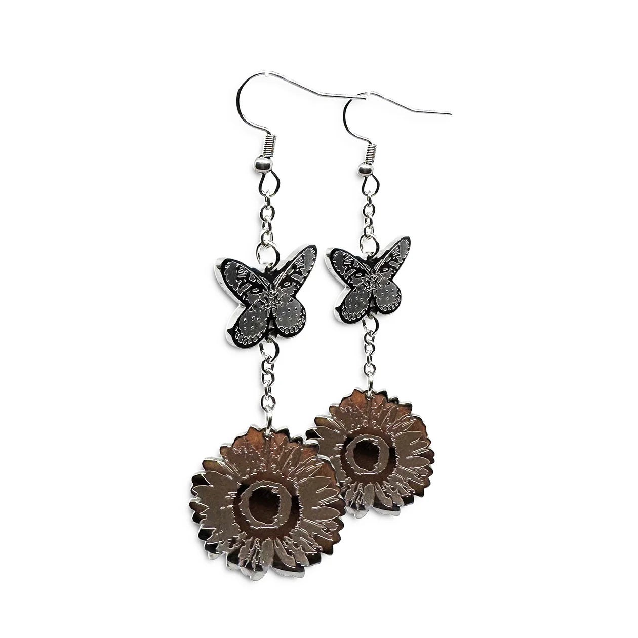 Close-up of Indie Ovation Butterfly & Sunflower earrings in stainless steel, 1-inch engraved nature design