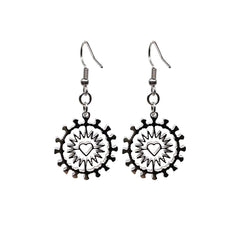 Close-up of Indie Ovation Corona Heart earrings in stainless steel, 1-inch geometric heart and corona design