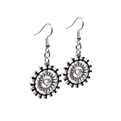 Close-up of Indie Ovation Corona Heart earrings in stainless steel, 1-inch geometric heart and corona design