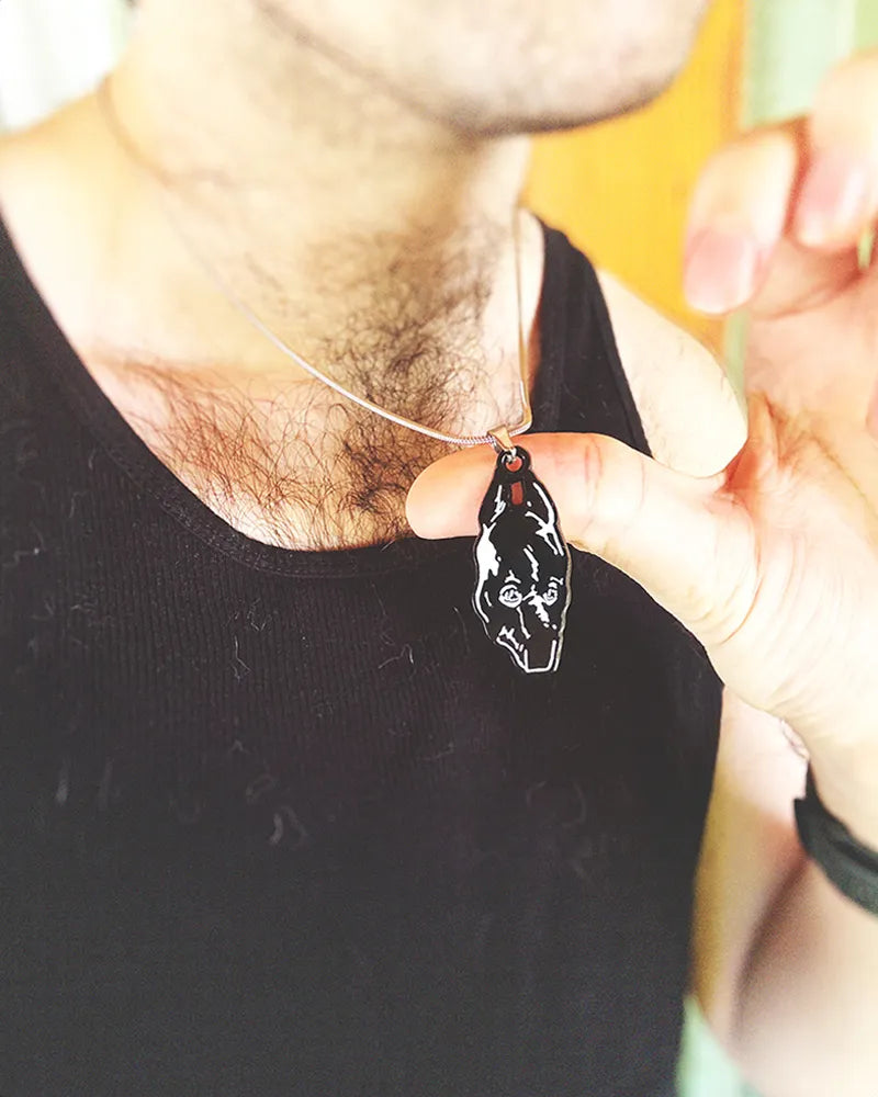 Man wearing a 1-inch enamel necklace inspired by Death Grips' Money Store