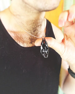 Man wearing a 1-inch enamel necklace inspired by Death Grips' Money Store