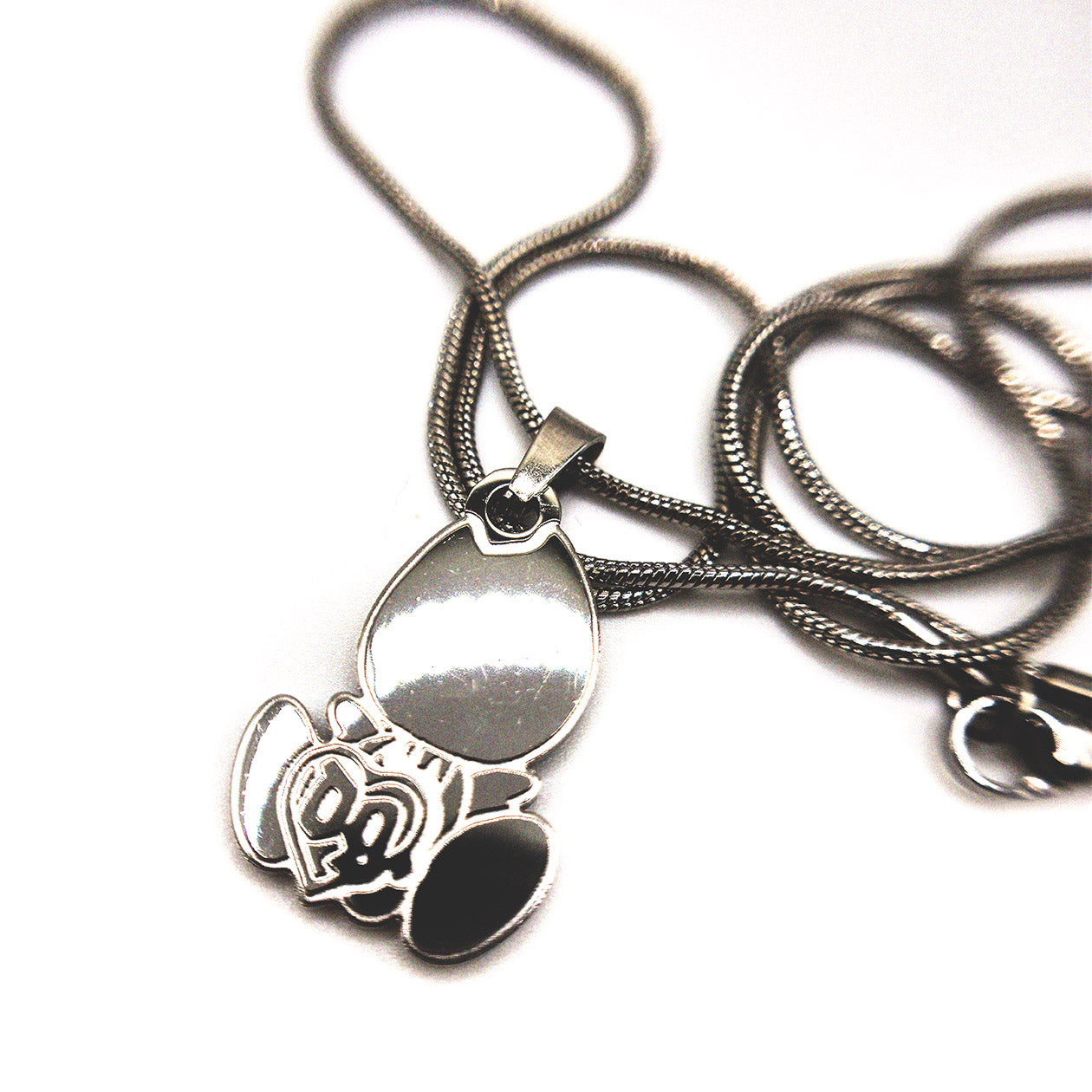 Front-facing product photo of the Drain Gang baby logo necklace pendant on chain