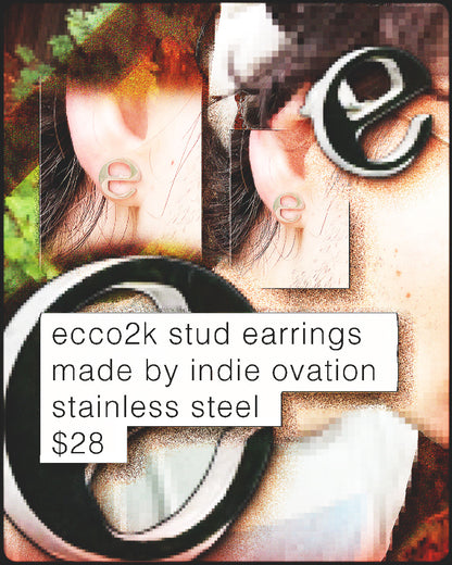 Person wearing Ecco2k 'E' logo stainless steel stud earrings – subtle fan accessory, 0.5-inch size