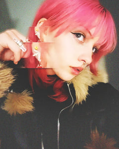 Cute girl wearing Aphex Twin logo small stud earrings – 0.5-inch stainless steel fan accessory