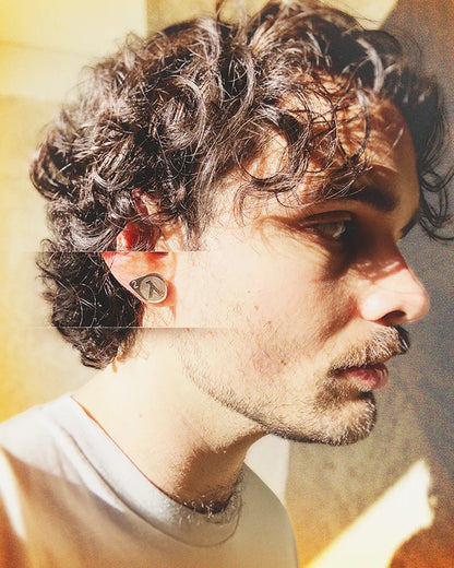 Portrait of a man wearing a 0.5-inch stainless steel earring inspired by Half-Life 2