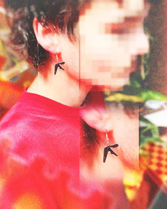 Man wearing Aphex Twin logo stainless steel dangly earrings – 0.75-inch fan-made design for Aphex Twin fans