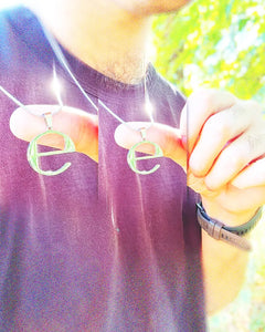 Man wearing Ecco2k 'E' album stainless steel pendant necklace – 1-inch fan-made minimalist design with 60cm chain