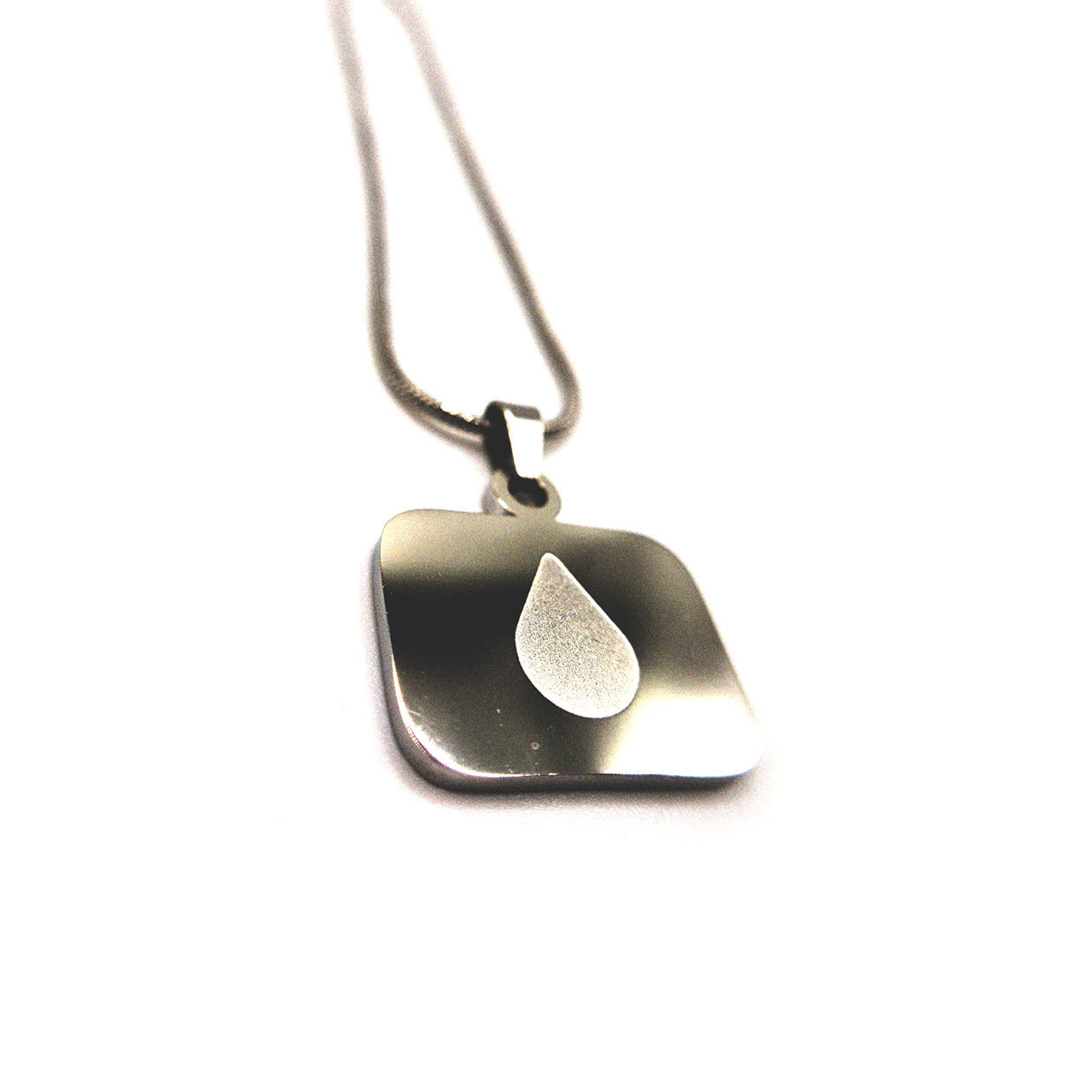 Close-up of Severance Lumon tear logo pendant necklace in polished stainless steel