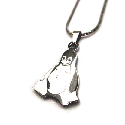 Close-up of Tux penguin stainless steel necklace, showing detailed engraving and shine