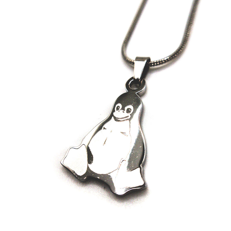 Close-up of Tux penguin stainless steel necklace, showing detailed engraving and shine