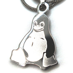 Stainless steel Tux penguin necklace displayed on a person’s fingers for size reference