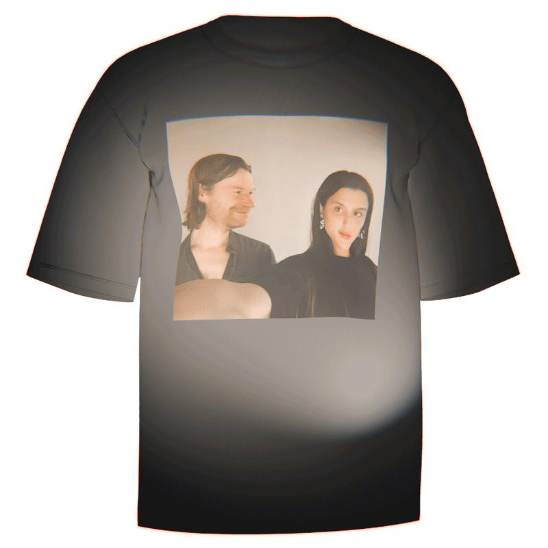 Flat-lay of a black Aphex Twin Arca T-Shirt showcasing a high-quality print of Arca and Richard D. James' iconic selfie. Crafted from durable and breathable Comfort Colors ringspun cotton. A must-have for fans of Aphex Twin and Arca.


