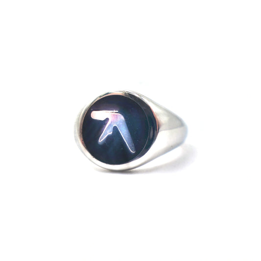 Stainless steel silver ring with an Aphex Logo on a black circular base