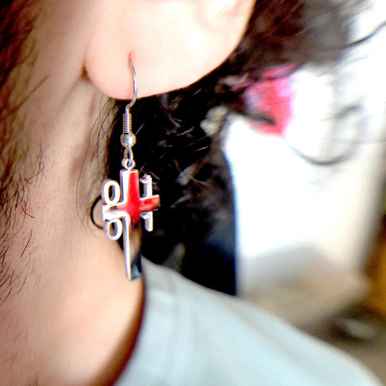 Close-up of Binary Architect Cross Earring worn on ear, showing polished cross with binary code, perfect for tech lovers and Christians.