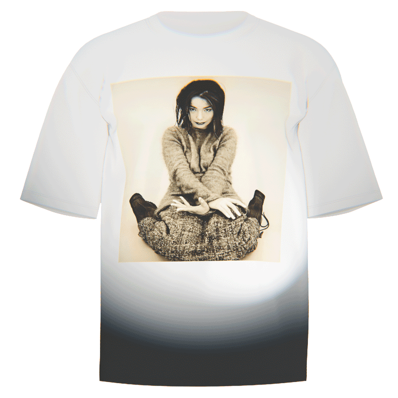 Flat-lay of a white Bjork "Debut" Portrait T-Shirt featuring a stylized portrait of Bjork from her iconic Debut album photoshoot. Made with ultra-soft Comfort Colors 100% ringspun cotton for a relaxed fit and breathable comfort. Perfect for fans of Bjork’s innovative artistry.