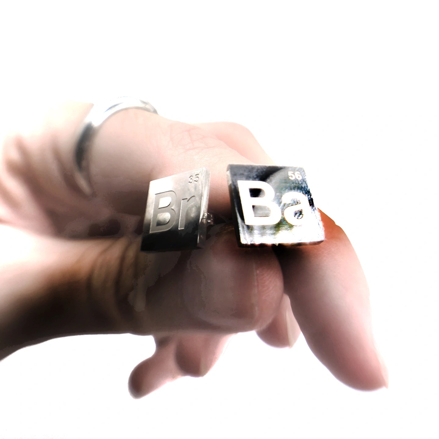 Silver steel stud earrings with elements "Br" and "Ba" referencing breaking bad