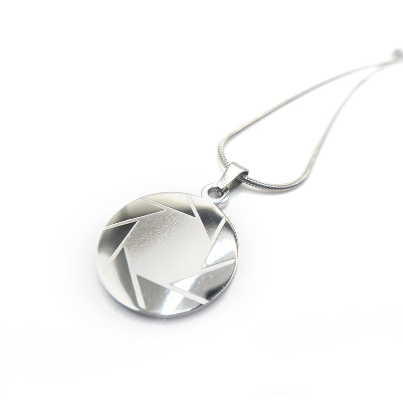 Silver geometric portal 2 aperture pendant necklace on a white background